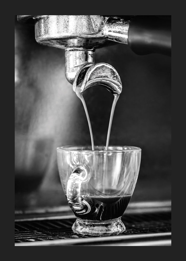 Black and white photo of espresso machine brewing coffee in cup-12