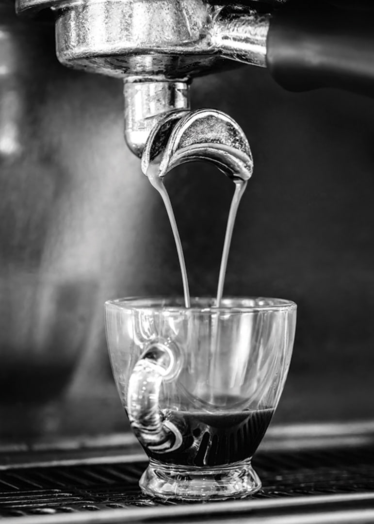 Black and white photo of espresso machine brewing coffee in cup-12
