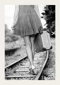 Black and white photograph of girl with suitcase on railway tracks-3