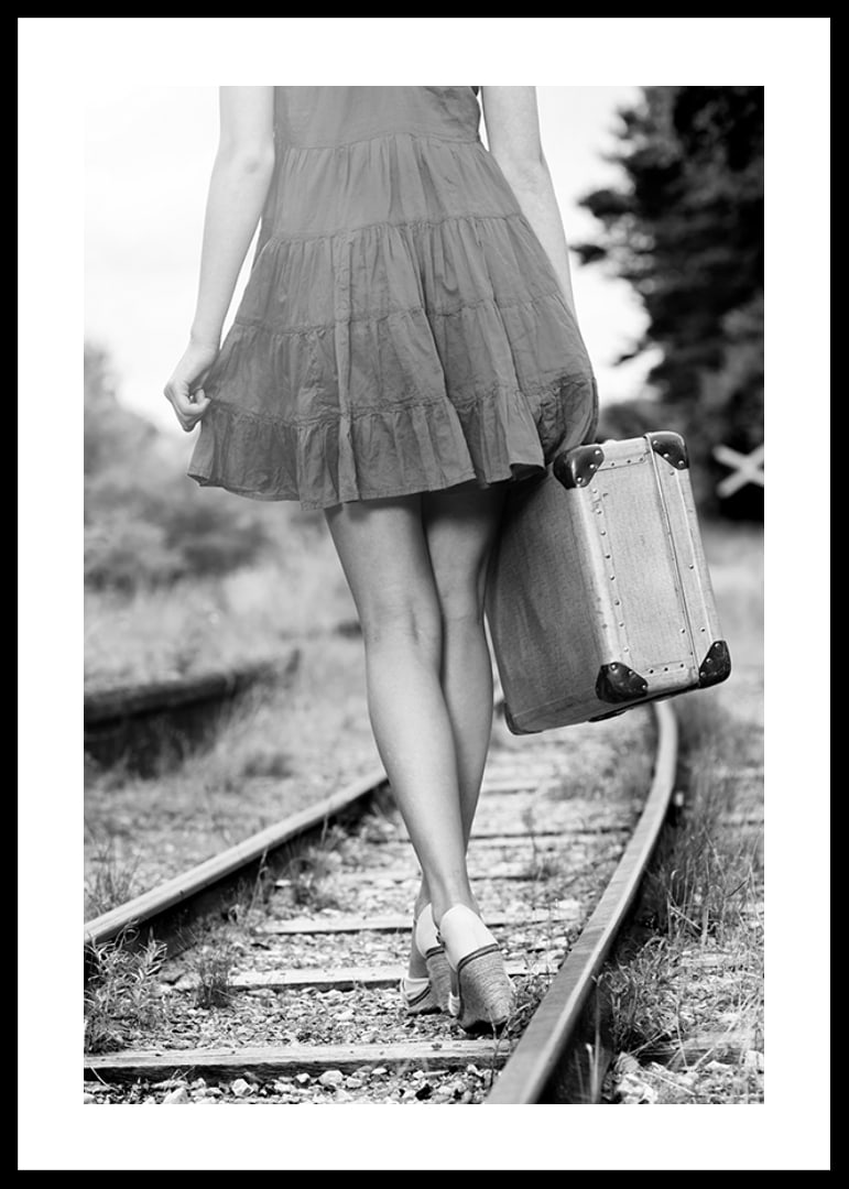 Black and white photograph of girl with suitcase on railway tracks-12