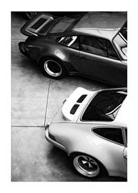 Svartvitt foto av två klassiska Porsche 911 ovanifrån-1