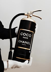 Stylized fire extinguisher in black and gold with Chanel label-7