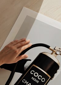 Stylized fire extinguisher in black and gold with Chanel label-9