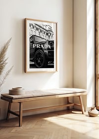 Black and white close-up of Mercedes G-Class in front of building with Prada text-8
