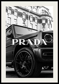 Black and white close-up of Mercedes G-Class in front of building with Prada text-2
