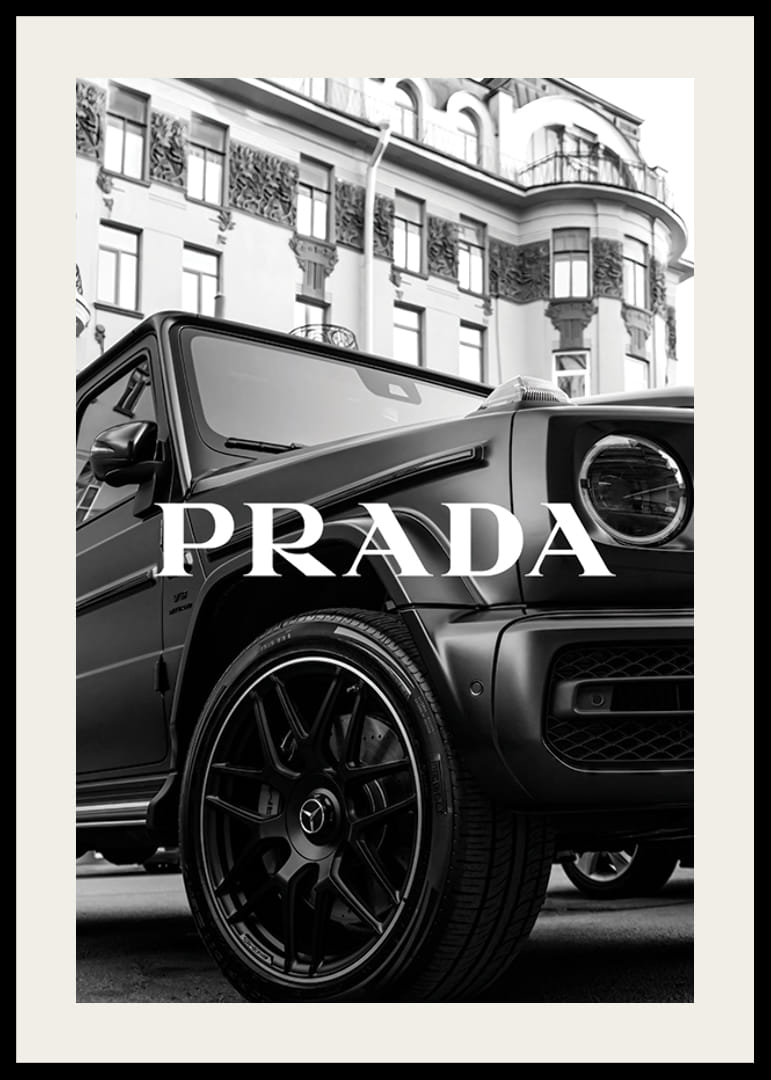 Black and white close-up of Mercedes G-Class in front of building with Prada text-12
