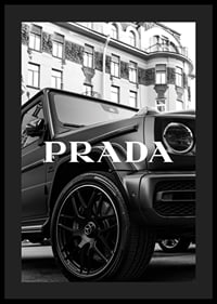 Black and white close-up of Mercedes G-Class in front of building with Prada text-4