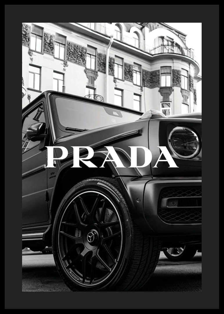 Black and white close-up of Mercedes G-Class in front of building with Prada text-12