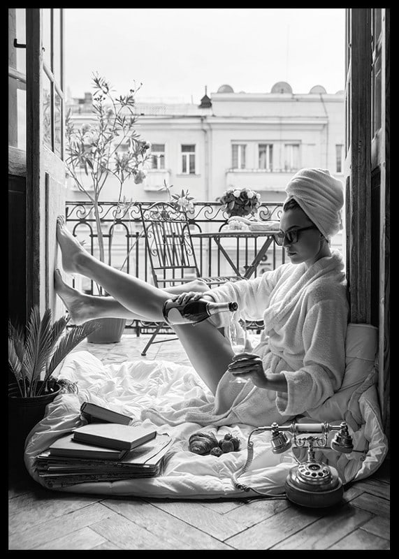 Black and white photo of woman in bathrobe on balcony-12