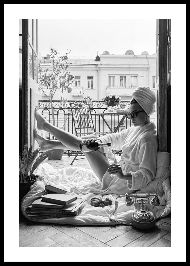 Black and white photo of woman in bathrobe on balcony-12