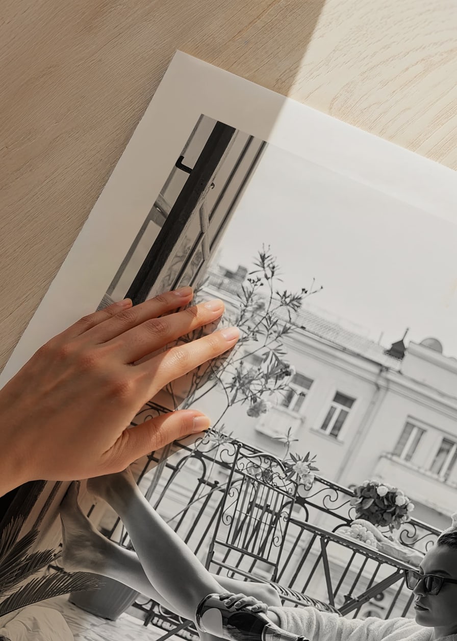 Black and white photo of woman in bathrobe on balcony-12