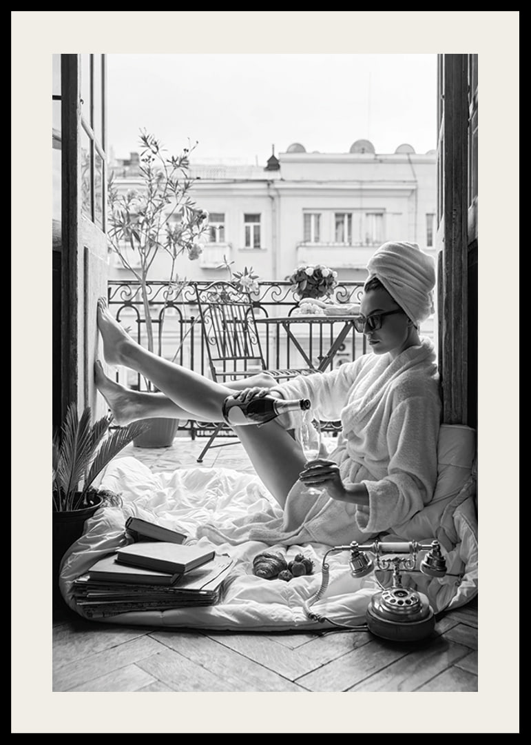 Black and white photo of woman in bathrobe on balcony-12