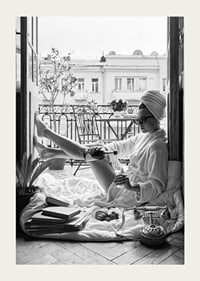 Black and white photo of woman in bathrobe on balcony-3
