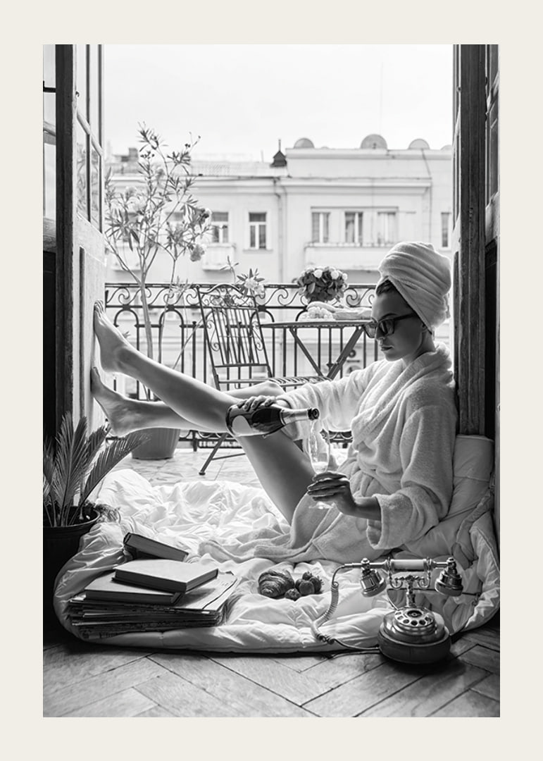 Black and white photo of woman in bathrobe on balcony-12