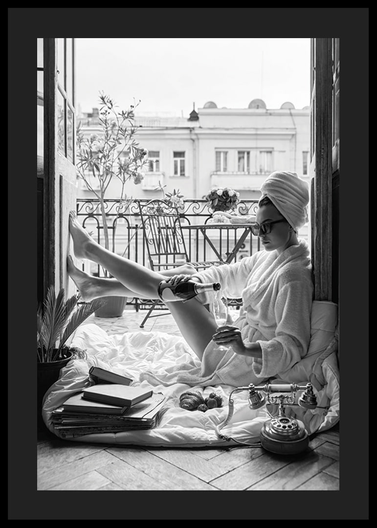 Black and white photo of woman in bathrobe on balcony-12
