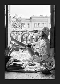 Black and white photo of woman in bathrobe on balcony-5