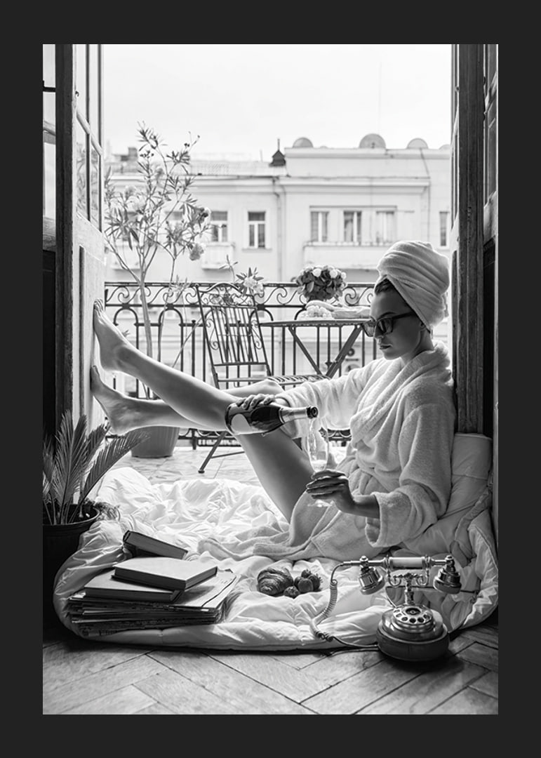 Black and white photo of woman in bathrobe on balcony-12
