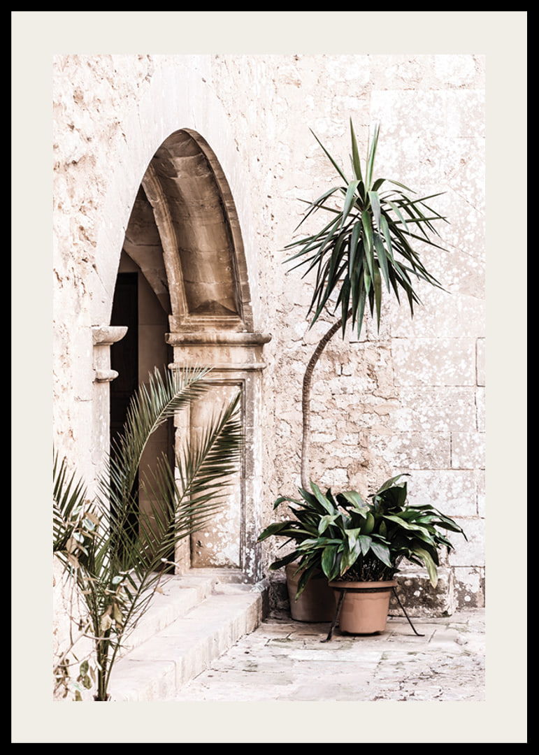 Photograph of stone arches and potted plants in a bright Mediterranean setting-12