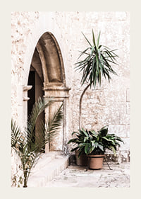Photograph of stone arches and potted plants in a bright Mediterranean setting-3