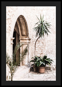 Photograph of stone arches and potted plants in a bright Mediterranean setting-4