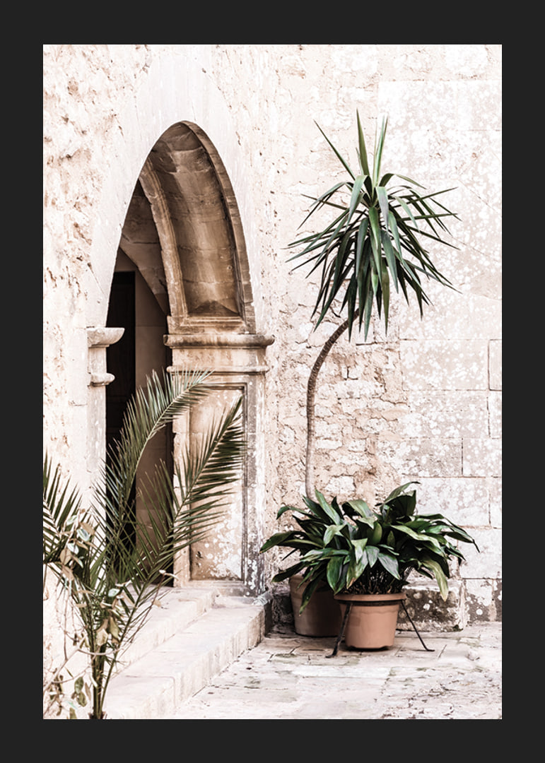 Photograph of stone arches and potted plants in a bright Mediterranean setting-12