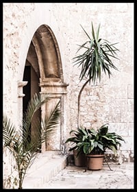 Photograph of stone arches and potted plants in a bright Mediterranean setting-6