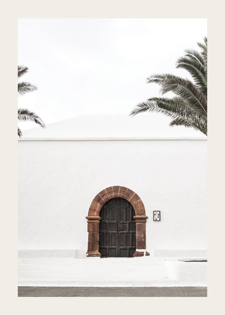 Photographic brown wooden door with stone arch in white plastered wall-12