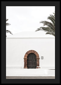Photographic brown wooden door with stone arch in white plastered wall-4