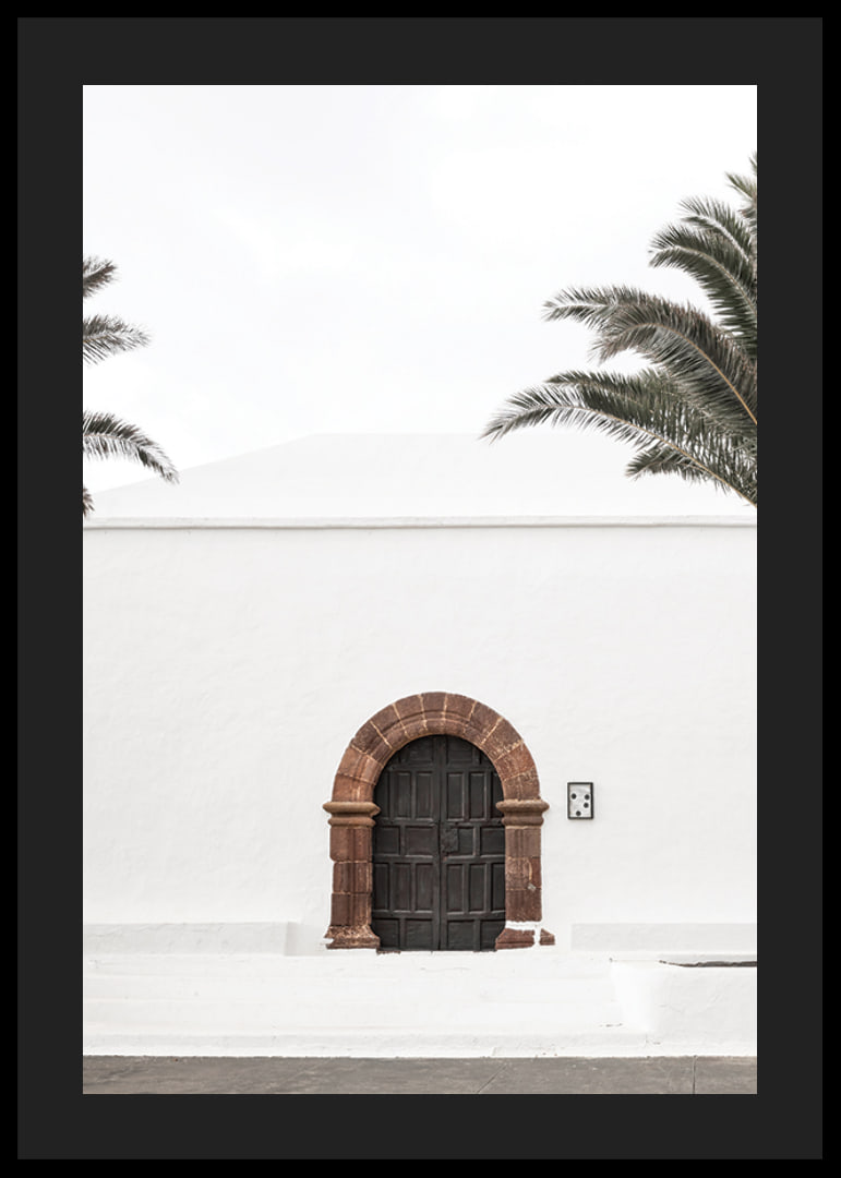 Photographic brown wooden door with stone arch in white plastered wall-12