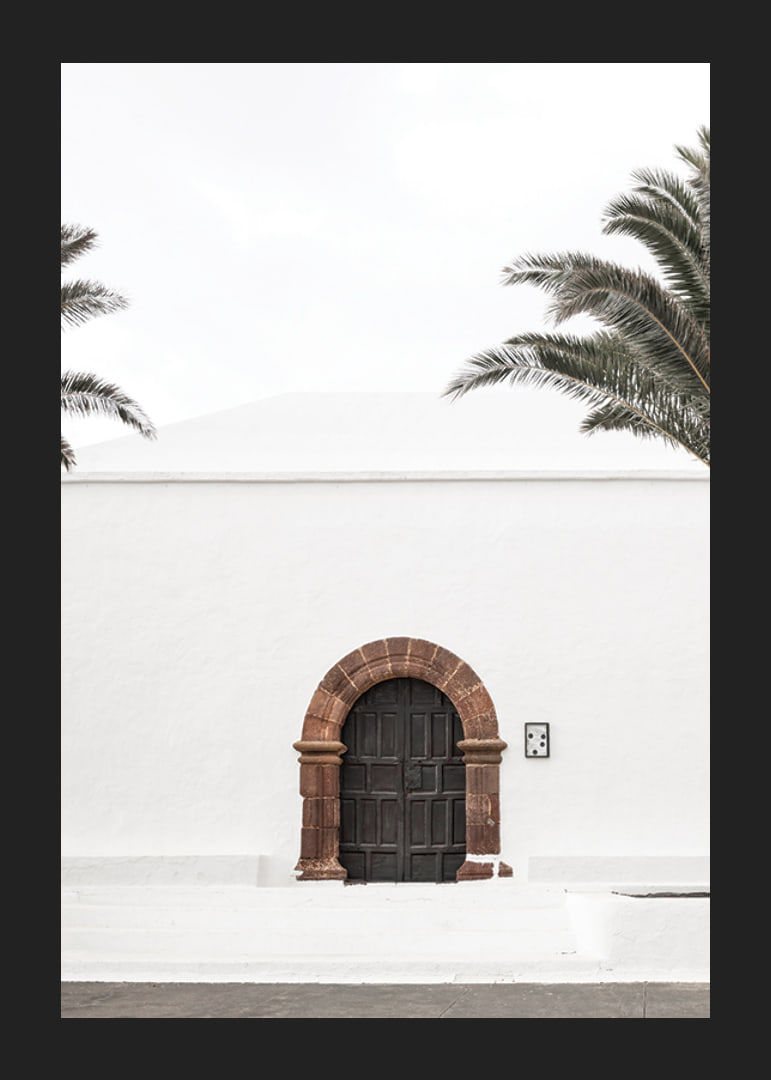 Photographic brown wooden door with stone arch in white plastered wall-12