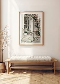 Photograph of white bicycle with flower basket in front of flower-adorned facade-8