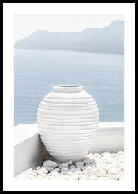 Photograph of white ceramic vase against sea and mountains on Santorini-0