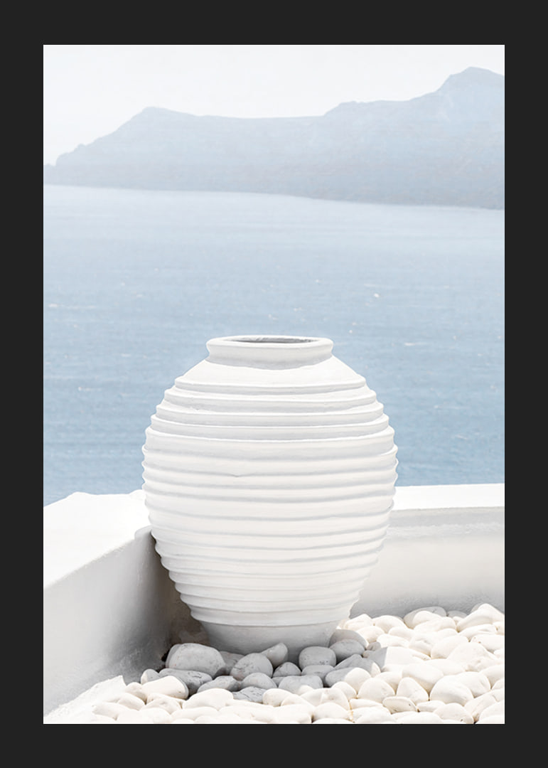 Photograph of white ceramic vase against sea and mountains on Santorini-12