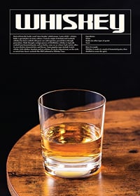 Photograph of whiskey glass on wooden table against black background-1