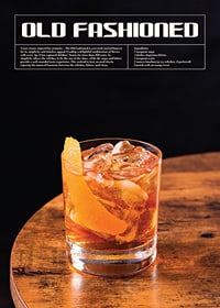 Old Fashioned cocktail with orange zest on wooden table-1