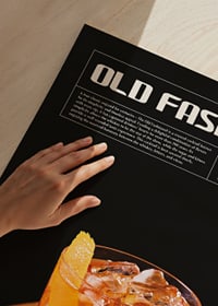 Old Fashioned cocktail with orange zest on wooden table-3