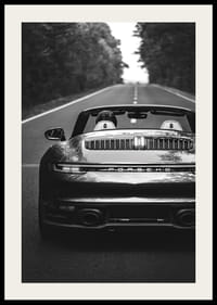 Black and white Porsche 911 convertible rear view on country road-2