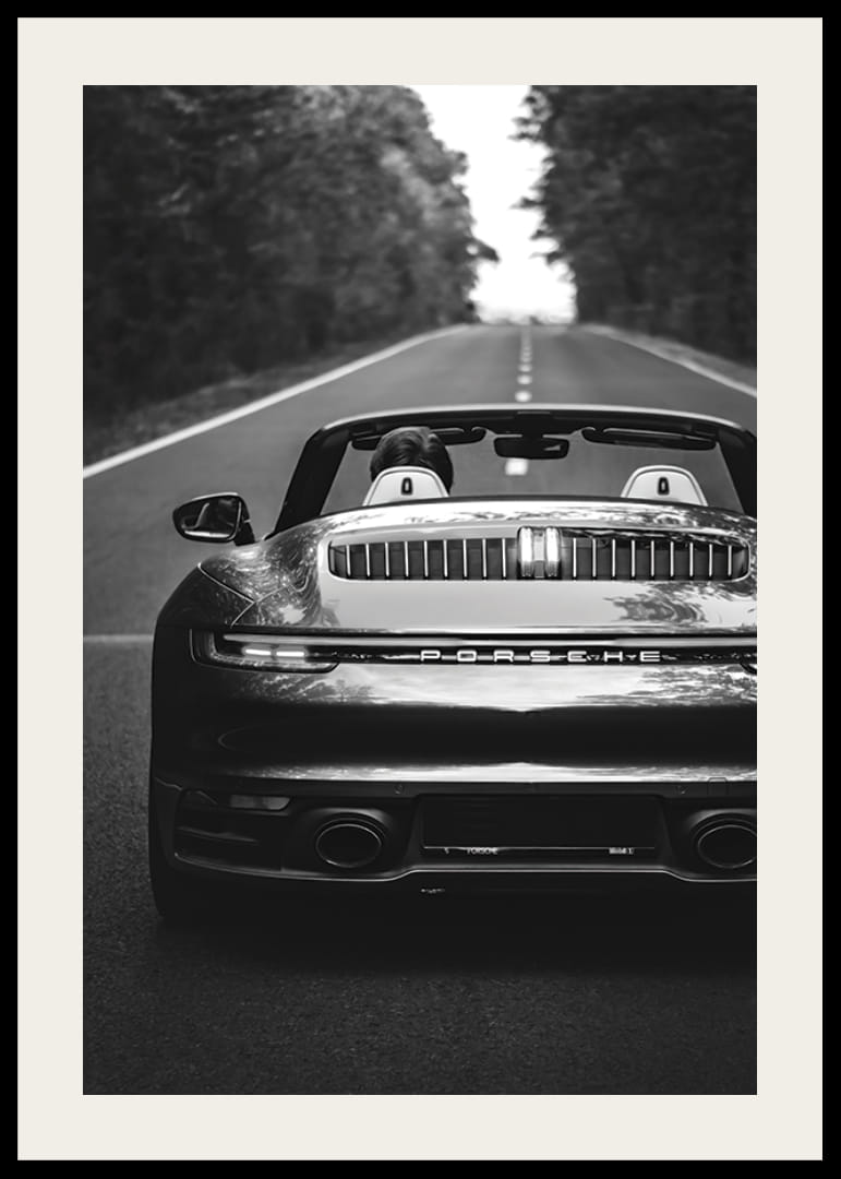 Black and white Porsche 911 convertible rear view on country road-12