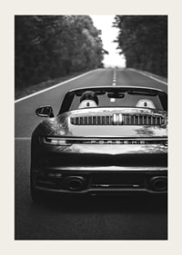 Black and white Porsche 911 convertible rear view on country road-3