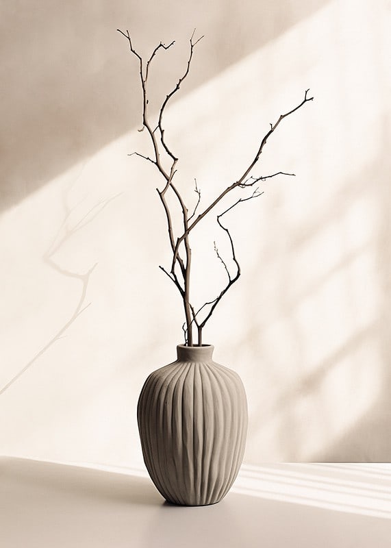 Ceramic vase with thin twigs against light, soft background-12