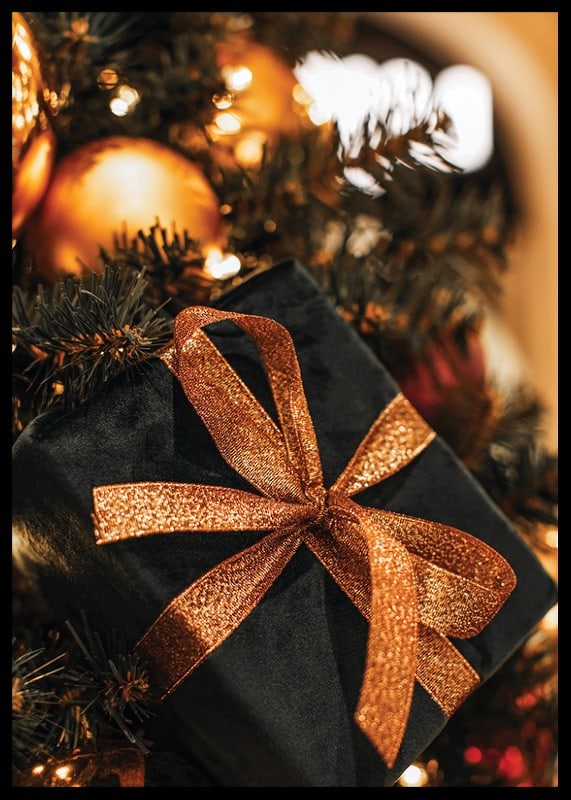 Close-up of black Christmas present with glittery ribbon among the branches of the fir tree-12