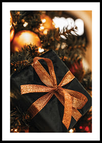 Close-up of black Christmas present with glittery ribbon among the branches of the fir tree-0