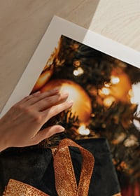 Close-up of black Christmas present with glittery ribbon among the branches of the fir tree-9