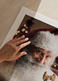 Jultomte med glas mjölk och chokladkaka i julmiljö-9