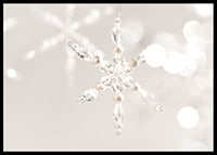 Close-up of sparkling crystal snowflake decoration against light background-6