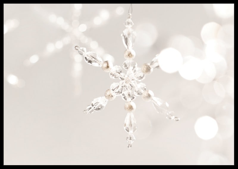 Close-up of sparkling crystal snowflake decoration against light background-12