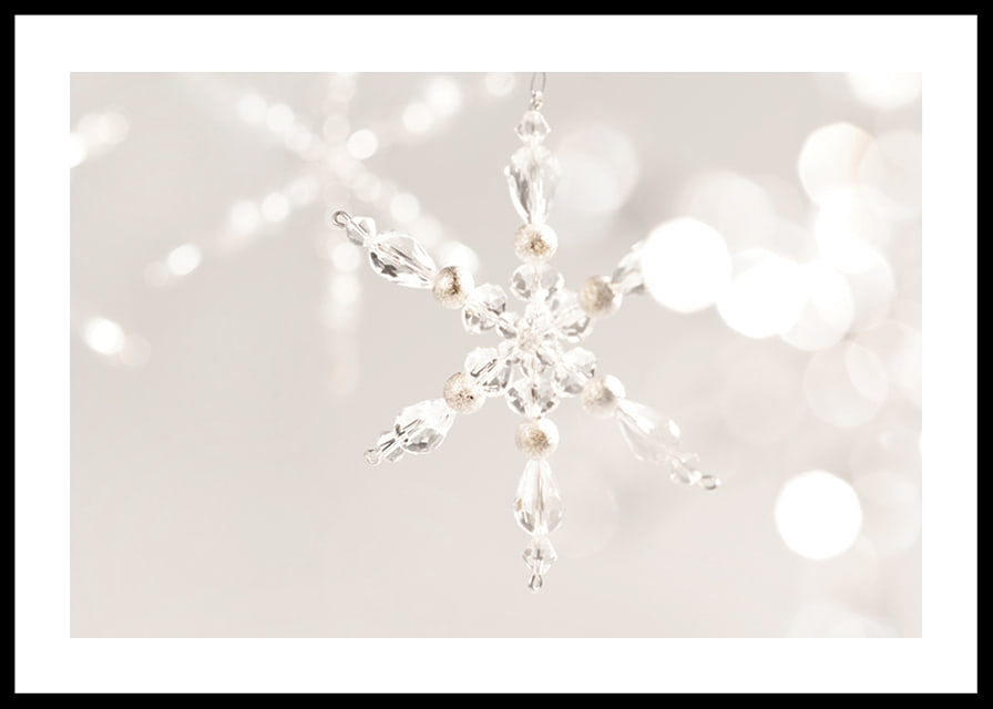 Close-up of sparkling crystal snowflake decoration against light background-12