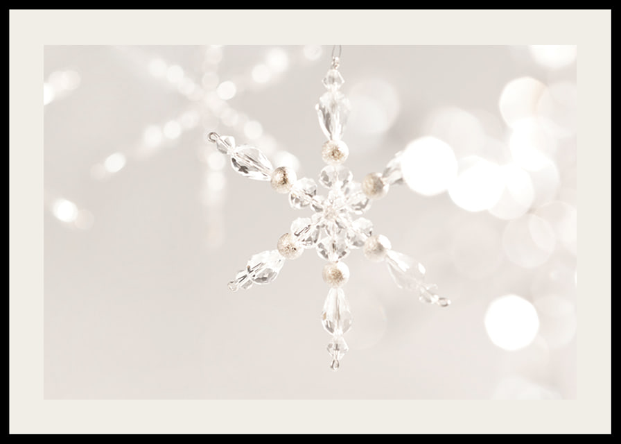 Close-up of sparkling crystal snowflake decoration against light background-12
