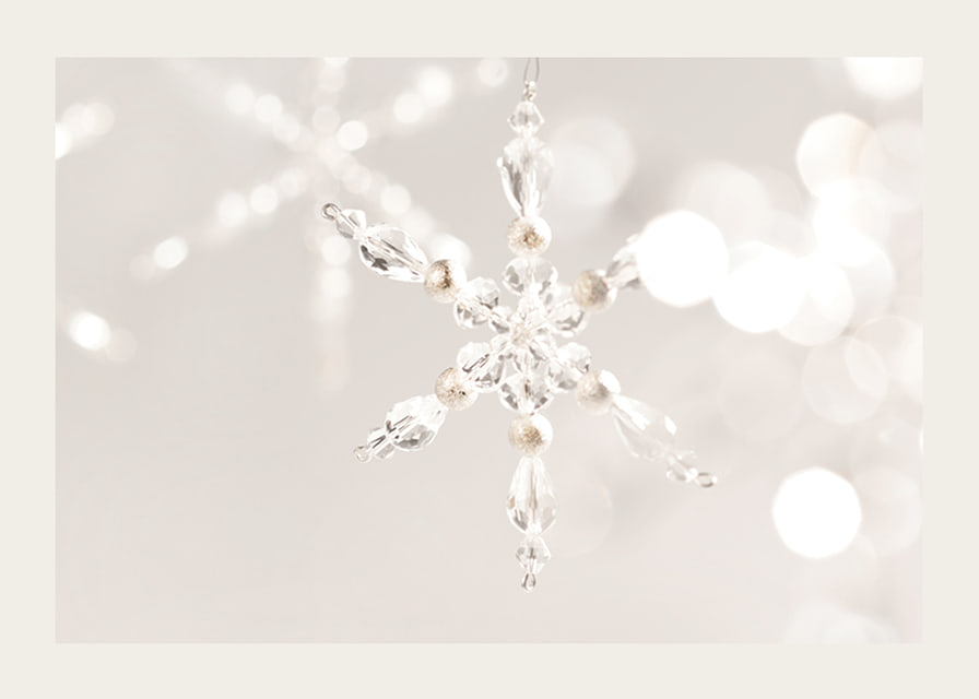 Close-up of sparkling crystal snowflake decoration against light background-12