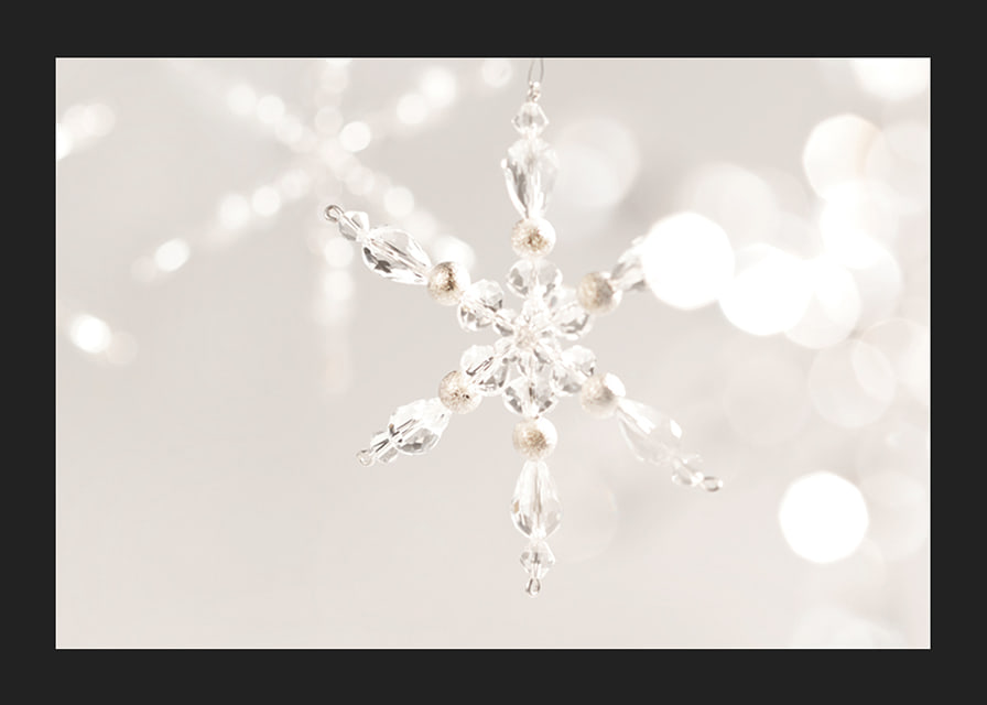 Close-up of sparkling crystal snowflake decoration against light background-12